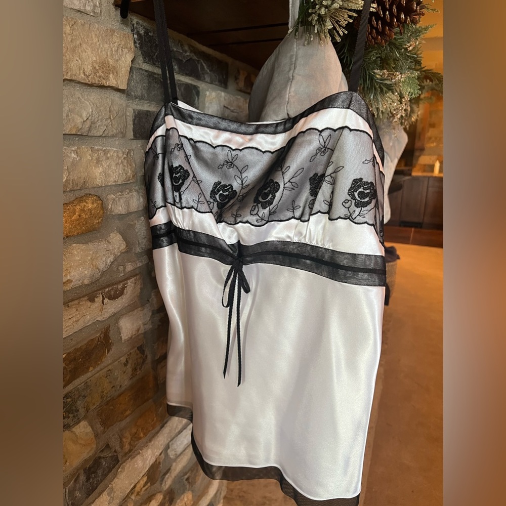 White Ann Taylor satin tank style blouse with black trim details.